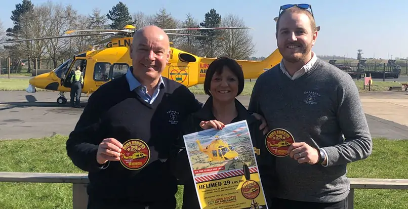 Batemans' Managing Director, Stuart Bateman promoting the Helimed 29 charity beer in front of the Lincs & Notts Air Ambulance Ambucopter.