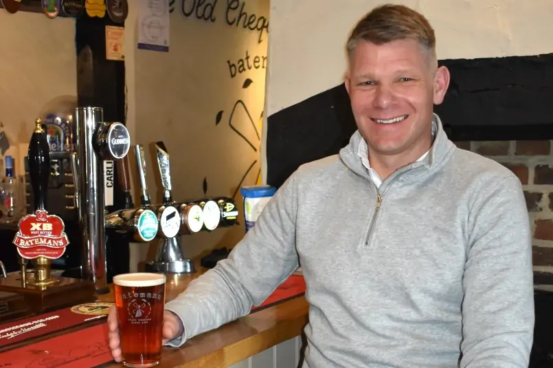 Batemans' Director of Sales, Chris Wright hold a pint of Batemans