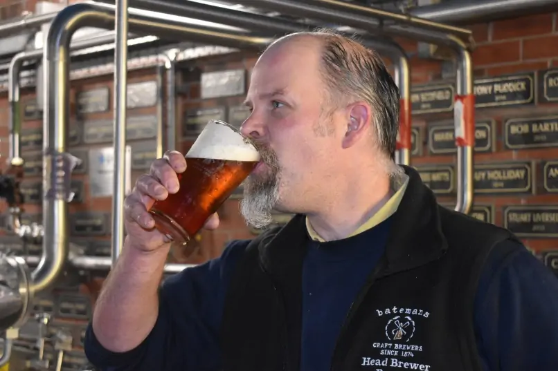 Batemans' Head Brewer, Bust Grant takes a sip on a Batemans pint