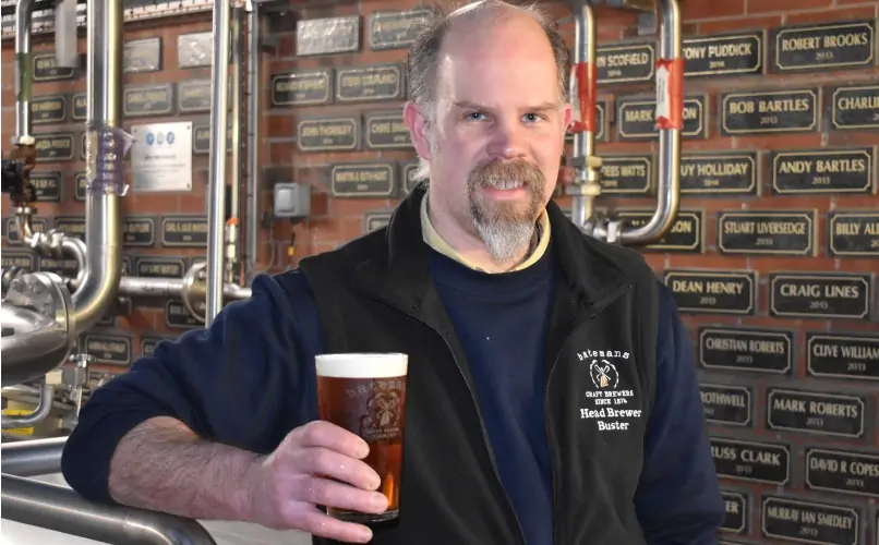 Batemans' New Head Brewer, Buster Grant holds a pint of Batemans