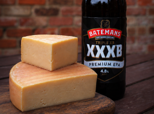 Bottle of Batemans XXB beer next to a cut block of cote hill lindum cheese