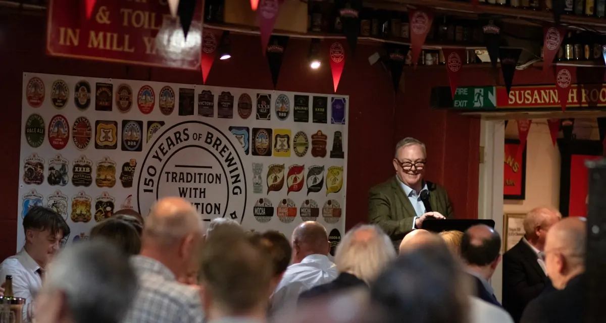 Batemans celebrate 150th anniversary with Brewers lunch - Keith Bott MBE with guests looking on enjoying the speech.