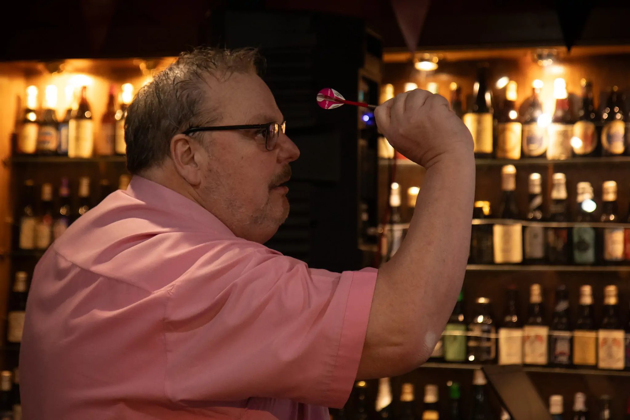 Peter Manley Pro Darts Player throwing at the Batemans 150th anniversary celebrations.