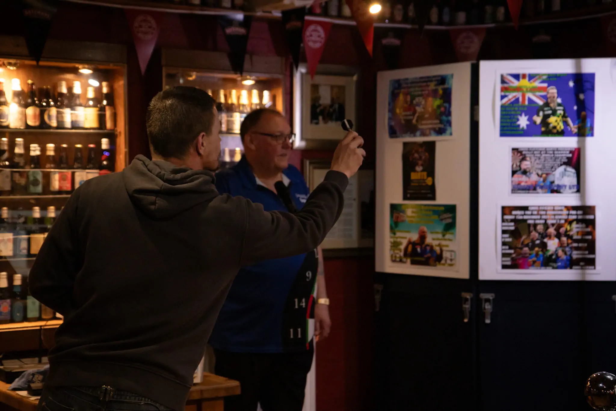 Peter Manley Pro Darts Player at the Batemans 150th anniversary celebrations darts with one of the competitors.