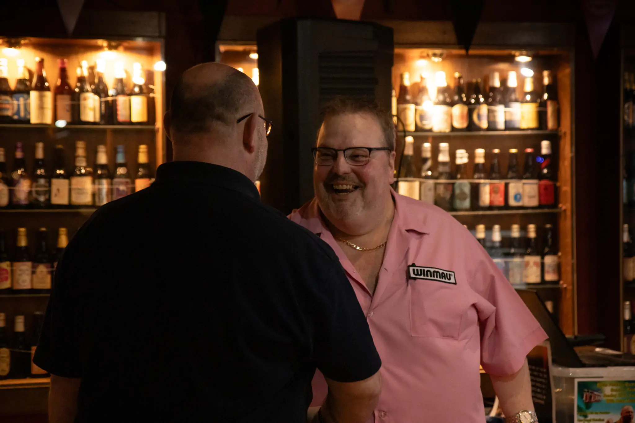 Peter Manley Pro Darts Player at the Batemans 150th anniversary celebrations darts with one of the competitors.