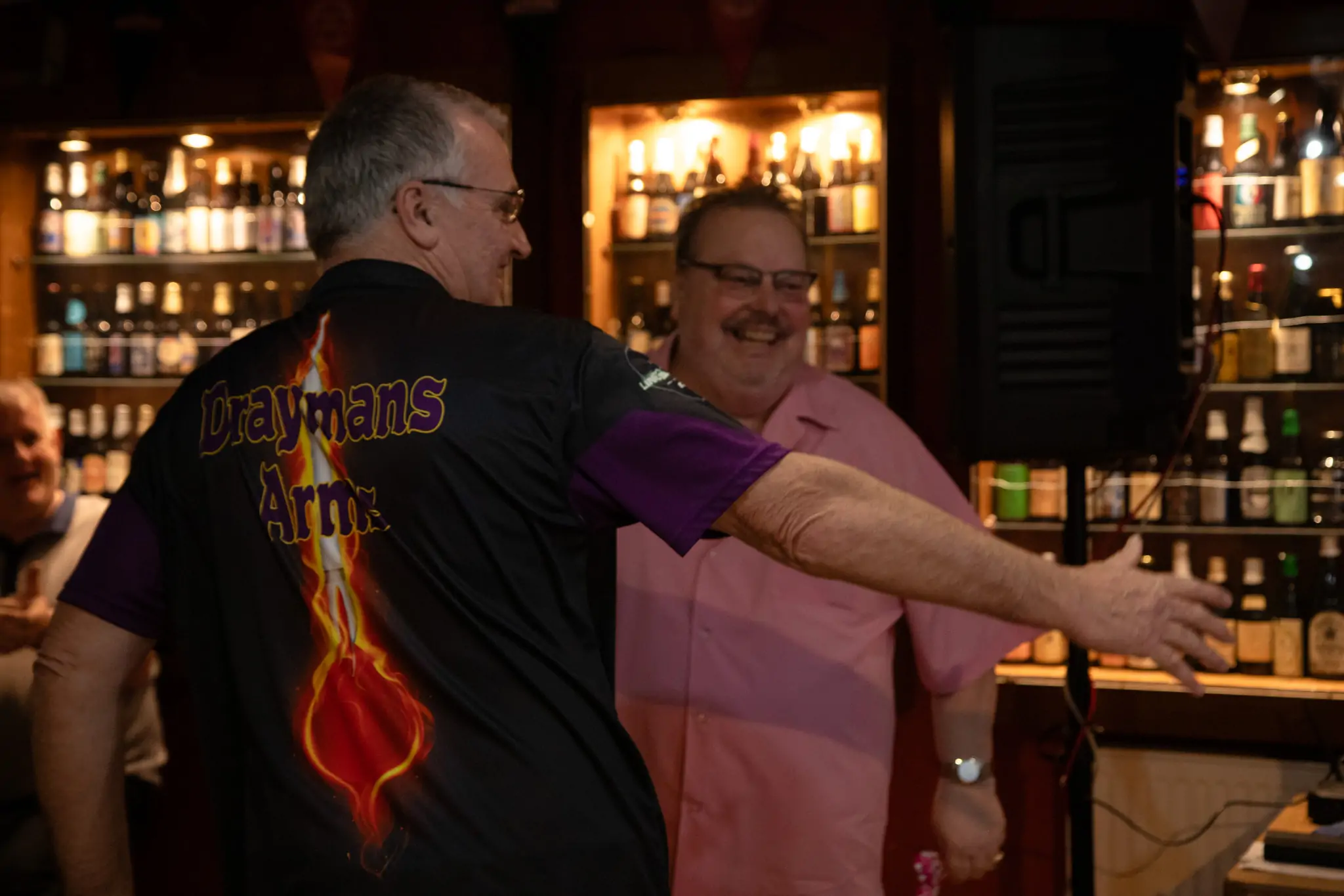 Peter Manley Pro Darts Player at the Batemans 150th anniversary celebrations darts with one of the competitors.