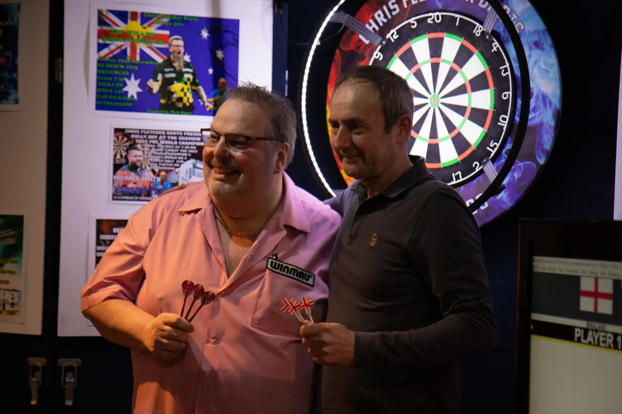 Peter Manley Pro Darts Player at the Batemans 150th anniversary celebrations darts with one of the competitors.