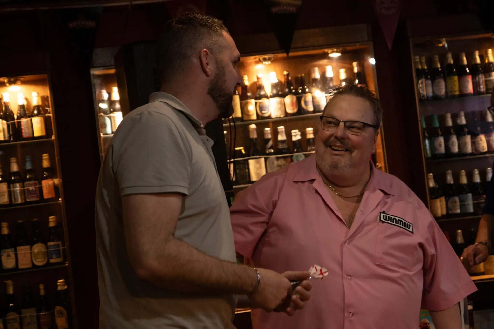 Peter Manley Pro Darts Player at the Batemans 150th anniversary celebrations darts with one of the competitors.