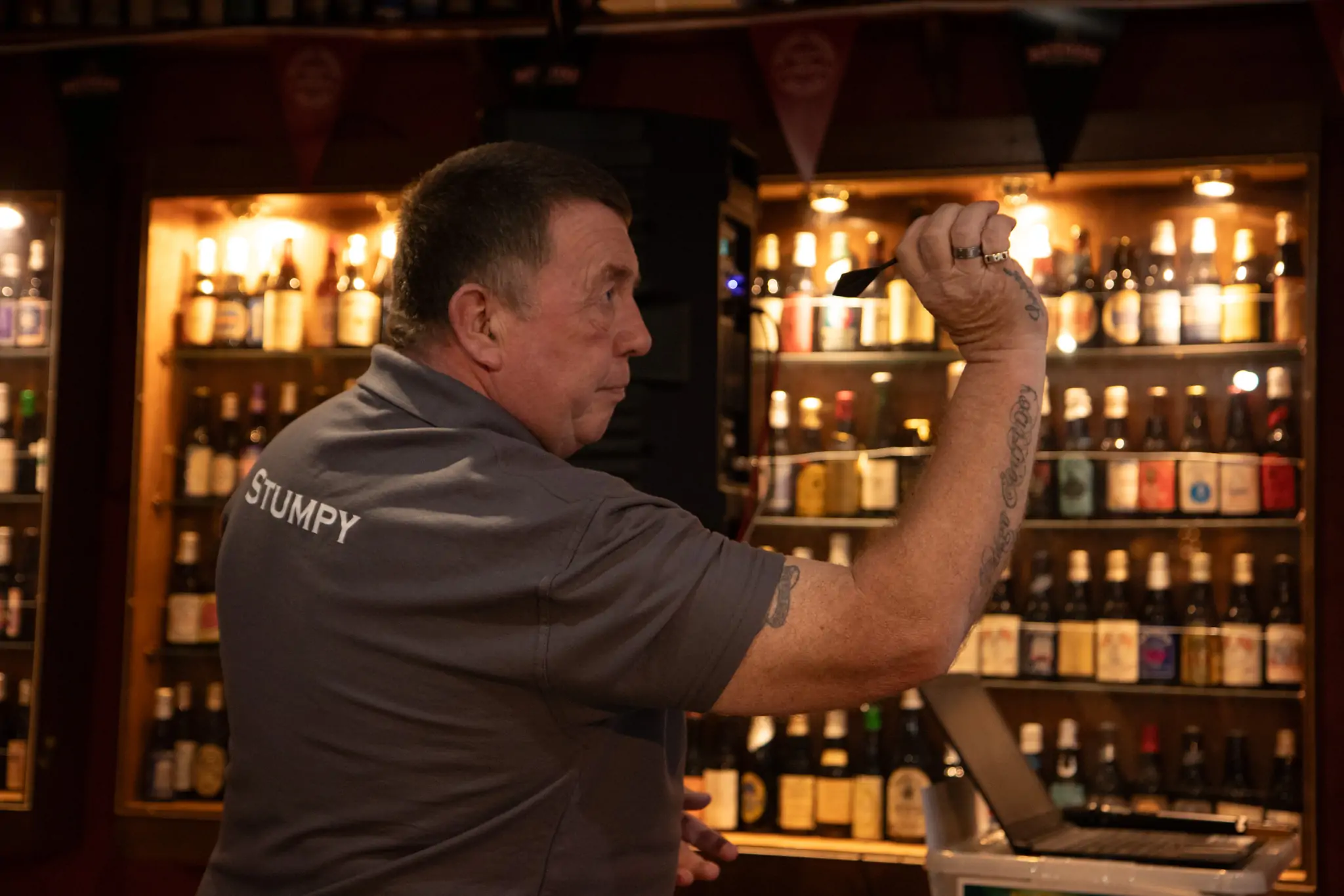 Peter Manley Pro Darts Player at the Batemans 150th anniversary celebrations darts with one of the competitors Mark Williams landlord from The White Hart, Old Leake, throwing his darts.