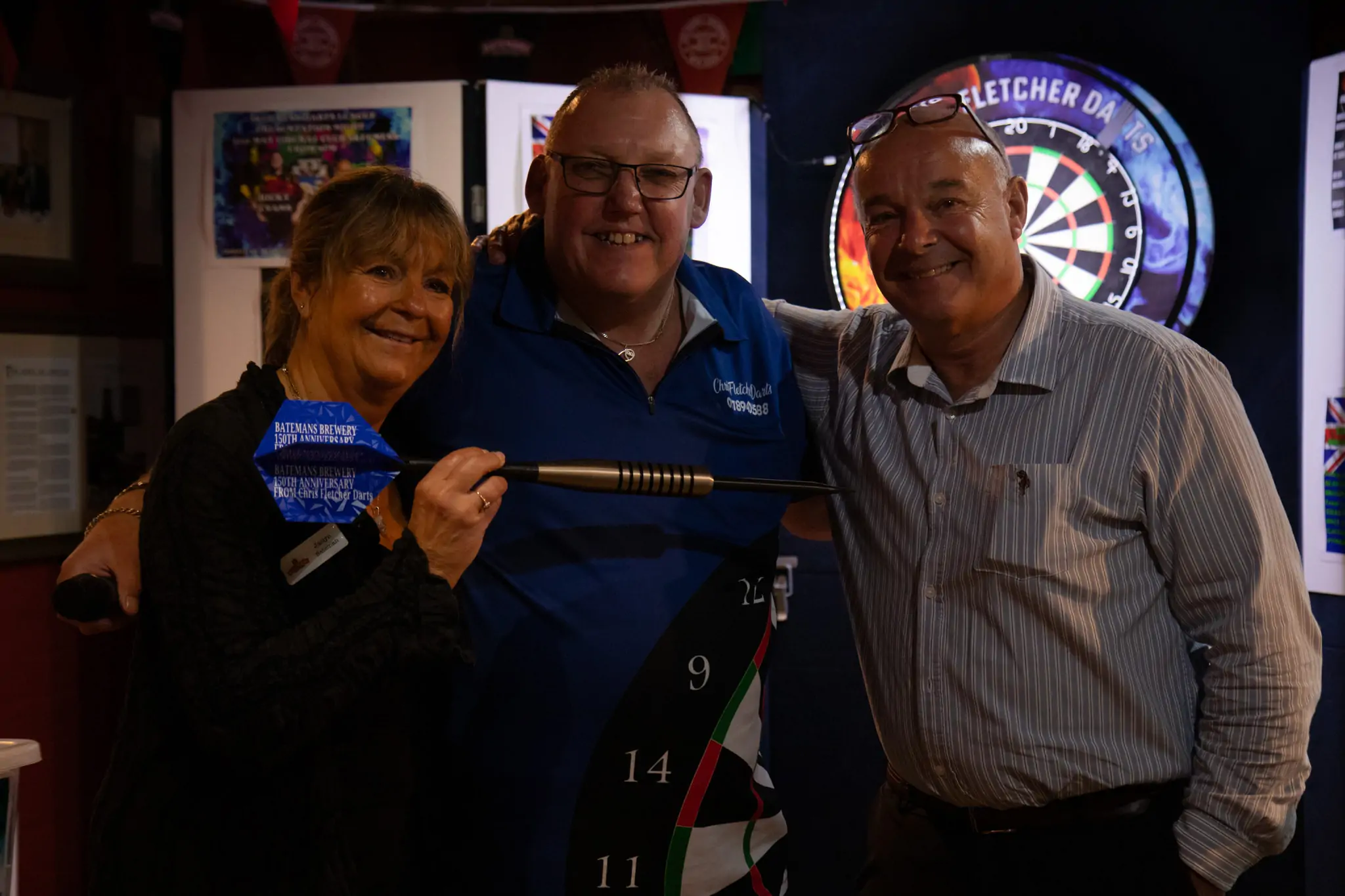 Peter Manley Pro Darts Player at the Batemans 150th anniversary celebrations darts - L-R Jaclyn Bateman, Chris Fletcher and Stuart Bateman.