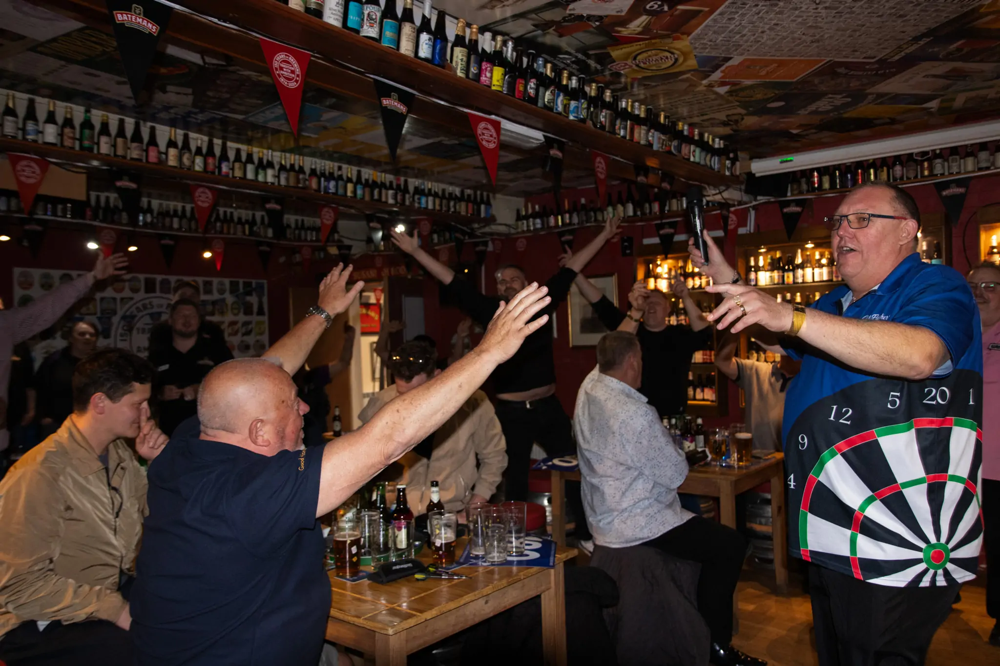 Peter Manley Pro Darts Player at the Batemans 150th anniversary celebrations darts - Chris Fletcher leads the sing along with the crowd.