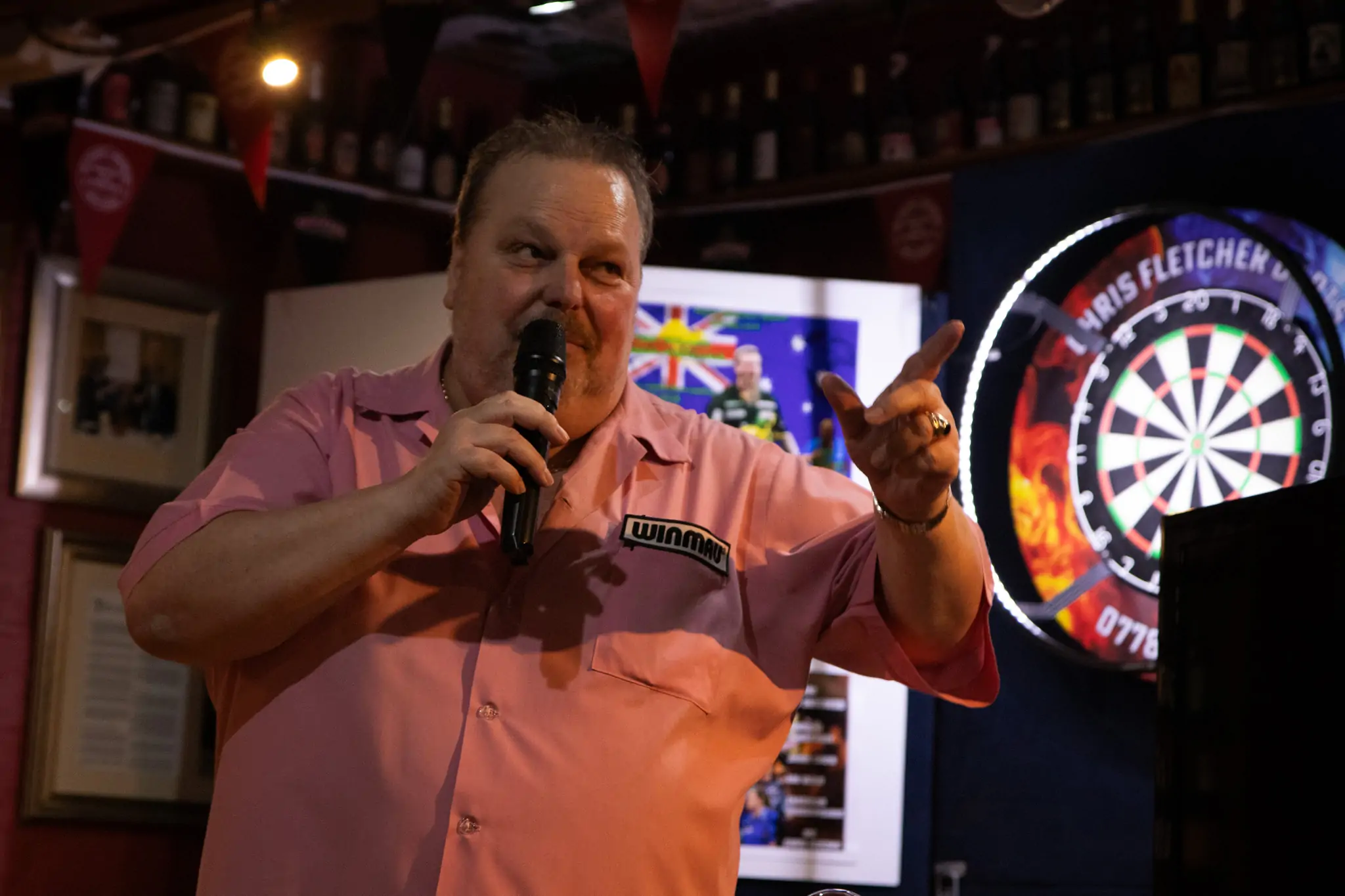 Peter Manley Pro Darts Player at the Batemans 150th anniversary celebrations darts competition talking on a microphone.
