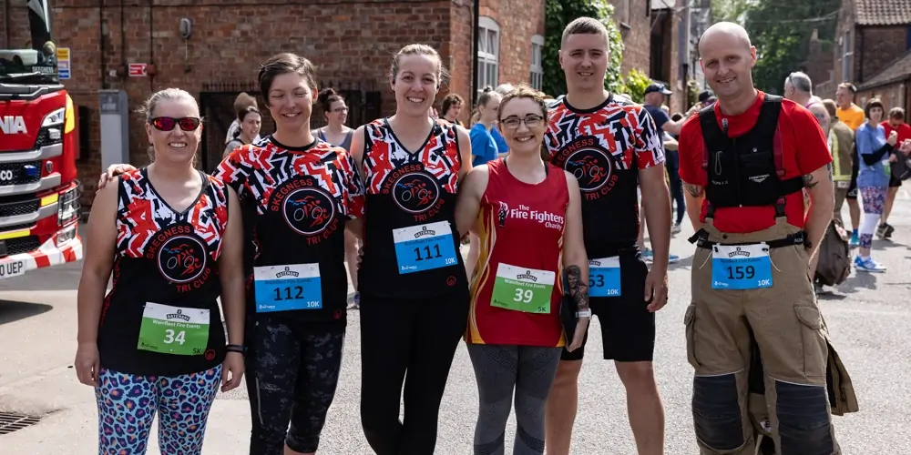 Five Generations Charity Fun Run - Runners from Skegness Tri Club and Fire Fights Charity posing for a picture