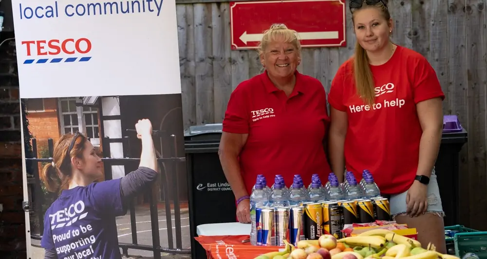 Five Generations Charity Fun Run - Tesco Local Community Sponsors at a table with water,, energy drinks and fruit